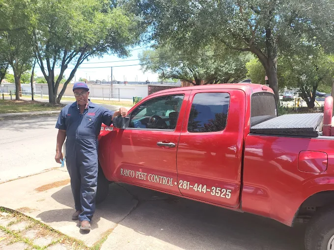 Pest control technician treating a home